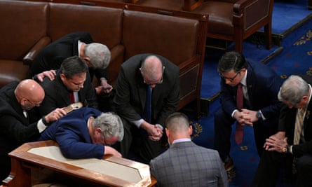 Mike Johnson and other Republican members of Congress kneel in prayer in the House chamber on January 6, 2023.