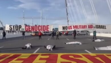 Pro-Palestinian protesters throw their car keys into the water as they close a major bridge during rush hour.