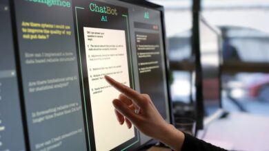 Close-up stock photograph showing a touchscreen monitor being used in an open plan office.