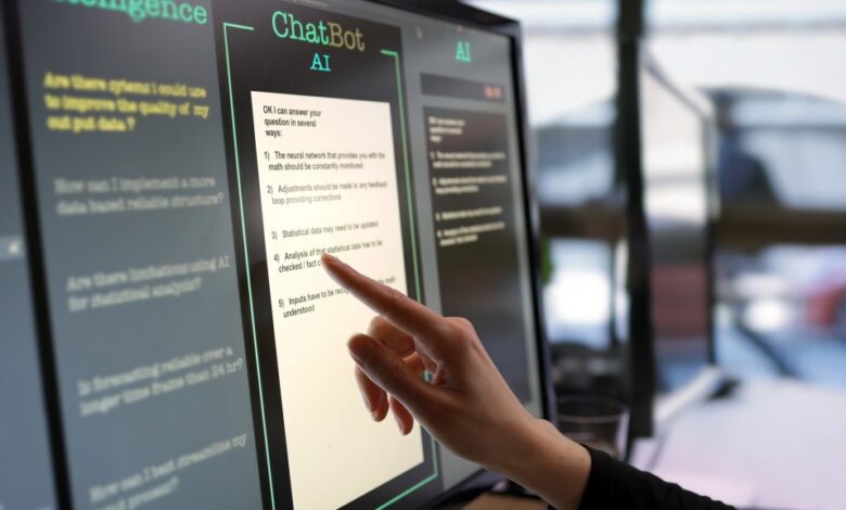 Close-up stock photograph showing a touchscreen monitor being used in an open plan office.