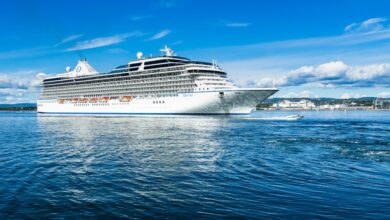 A big cruise ship overtaken by a speedboat in Oslo fjord. Oslo, Norway, August 2018