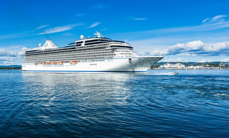 A big cruise ship overtaken by a speedboat in Oslo fjord. Oslo, Norway, August 2018