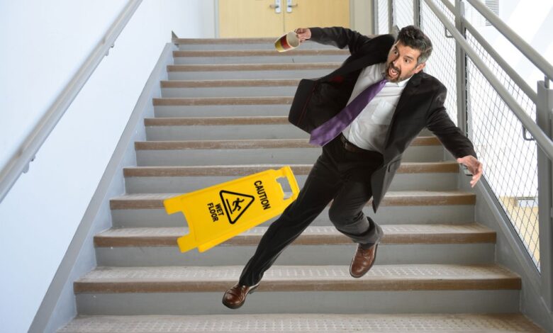 A man holding a phone falling down the stairs.