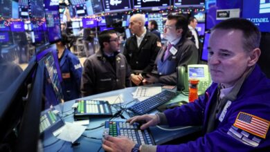 Traders work on the floor at the New York Stock Exchange (NYSE) in New York City, U.S., December 11, 2023.