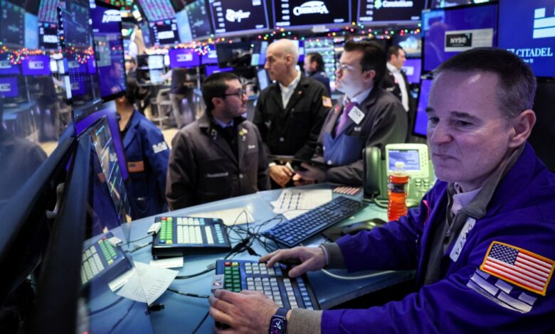 Traders work on the floor at the New York Stock Exchange (NYSE) in New York City, U.S., December 11, 2023.