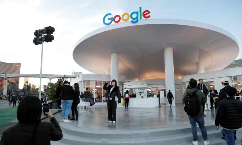 An attendee has her photo taken in front of the Google house at CES 2024, an annual consumer electronics trade show, in Las Vegas, Nevada,