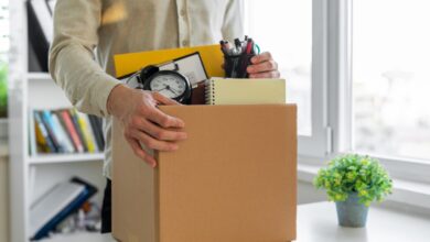 Sad dismissed worker taking his office supplies with him.