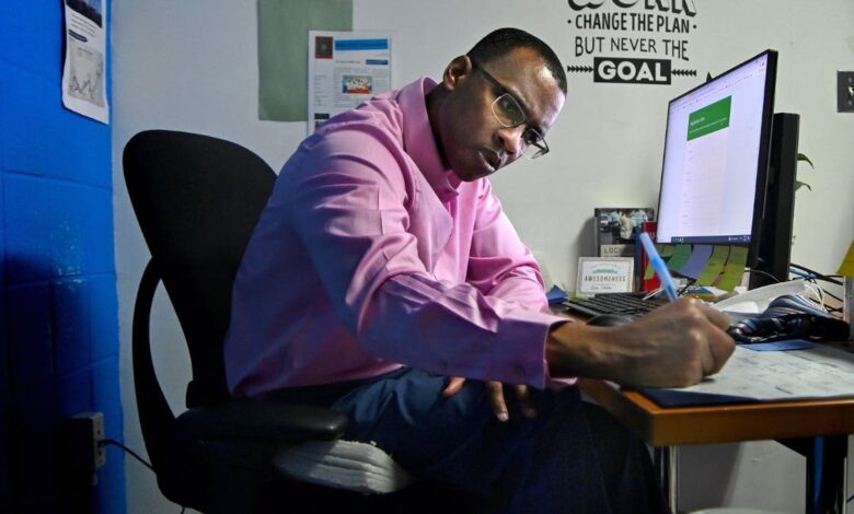 An inmate writing in his office at a jail