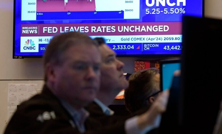 A television screen on the floor of the New York Stock Exchange displays the Federal Reserve's decision on interest rates, Jan. 31, 2024.