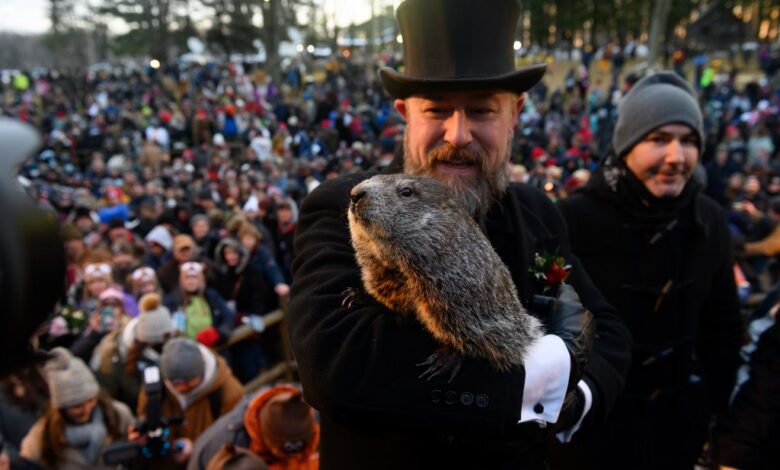 Groundhog handler AJ Derume holds Punxsutawney Phil, who saw his shadow, predicting a late spring during the 136th annual Groundhog Day festivities