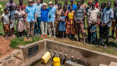 Ramon and Bob Billhimer (left center in blue) providing clean water to Uganda.