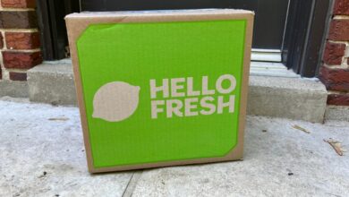 A green Hello Fresh delivery box on concrete.