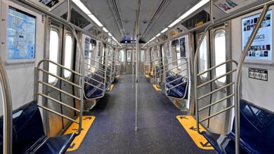 Photo shows the inside of a NYC subway car.