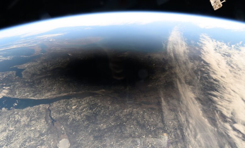 The Moon's shadow, or umbra, is pictured covering portions of the Canadian provinces of Quebec and New Brunswick and the American state of Maine in this photograph from the International Space Station as it soared into the solar eclipse from 261 miles above.