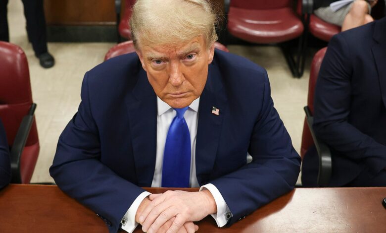 Donald Trump sits in the courtroom for the first day of opening arguments in his Manhattan criminal trial.