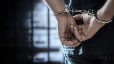 A stock photo of a man in handcuffs