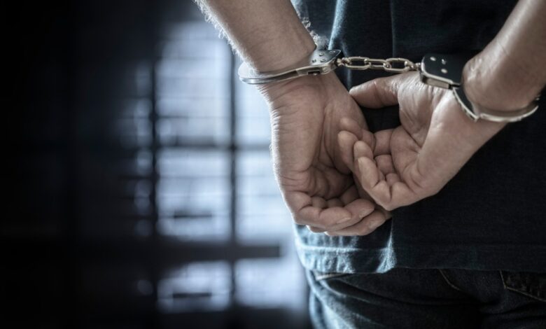 A stock photo of a man in handcuffs