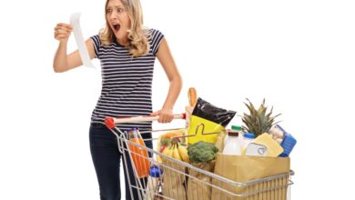 Stock photo of woman looking at a store receipt.