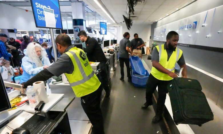 Passenger drop off their baggage.