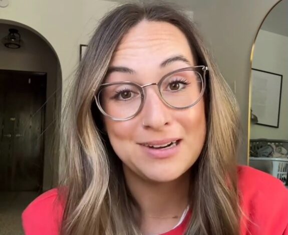 Emily Wehner wearing glasses expressing her opinion in a viral video about Mother's Day controversy