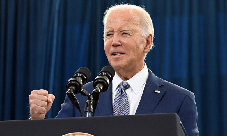 Joe Biden talking at podium, making a fist