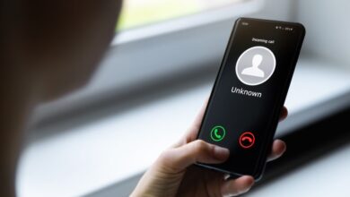 Woman holding a mobile phone with an incoming call from an unknown caller, poised to hang up for data safety