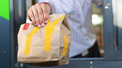 McDonald's worker in Sankt-Petersburg, Russia handing over a bag of fast food through the drive-thru window on July 21, 2019.