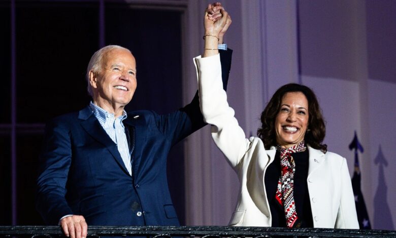 President Joe Biden and Vice President Kamala Harris hold hands on balcony