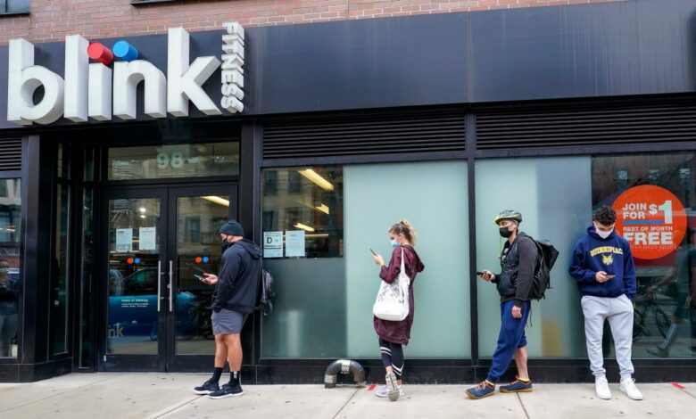 People queued outside Blink Fitness gym in Lower East Side neighborhood of New York, awaiting the lifting of mask requirements and vaccination mandates.