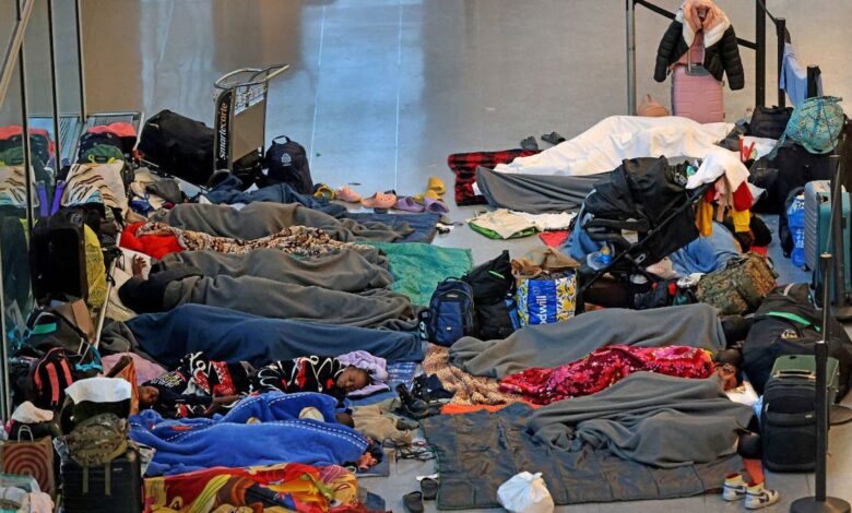 Migrants sleeping on the floor at Logan Airport