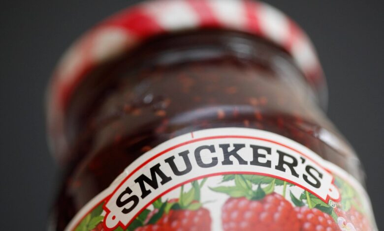 Close-up view of a jar of Smucker's preserves on a shelf.