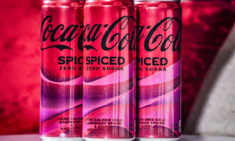 Cans of Coca-Cola Spiced being unveiled at a livestream media event in New York on February 6, 2024