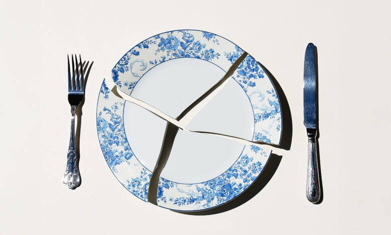 A broken plate with a fork and knife.