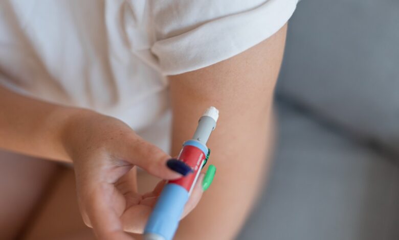 Girl administering a dose of anti-diabetic medication via injection pen at home for weight loss