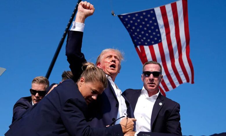 Trump pumping fist in air after first assassination attempt