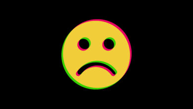 A frowning face with a yellow, pink, and green layer