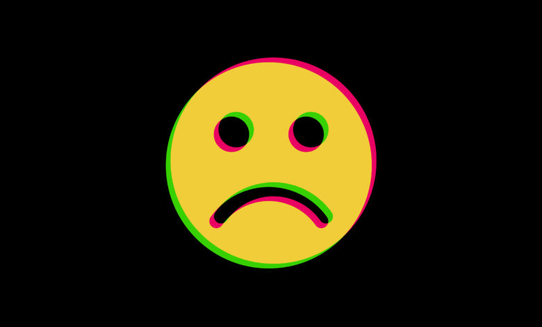 A frowning face with a yellow, pink, and green layer