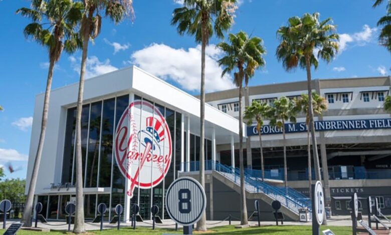 A building with a sign, surrounded by palm trees, likely related to Yankees Spring Training