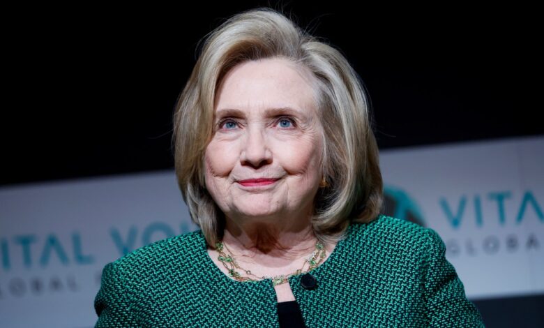 Hillary Clinton delivering a speech at the Vital Voices Global Festival in Washington, DC, wearing a green jacket