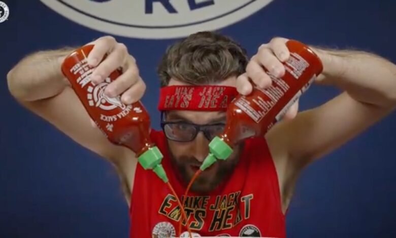 Spicy speed eater Mike Jack attempting to break the record for most hot sauce eaten in three minutes