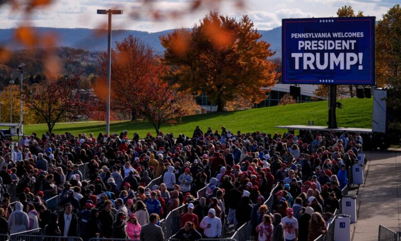 People wait in line to enter a Republican presidential nominee former President Donald Trump campaign event in State College, Pa., Saturday, Oct. 26, 2024.