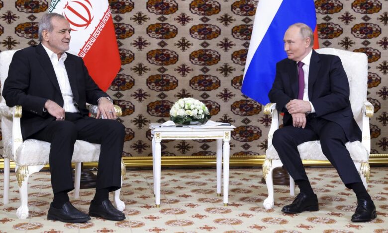 Russian President Vladimir Putin, right, met with Iranian President Masoud Pezeshkian, left, on Friday, hailing the "very close" relationship between Russia and Iran.