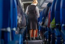 A woman walking down a plane