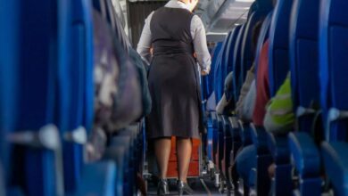 A woman walking down a plane