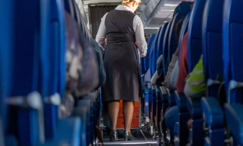 A woman walking down a plane