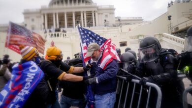 Rioters try to break through a police barrier at the Capitol on Jan. 6, 2021, in Washington