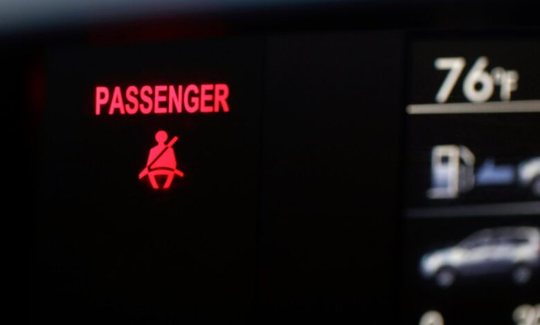 A seat belt warning sign for the right front passenger seat is displayed in a vehicle on Monday, Aug. 21, 2023.