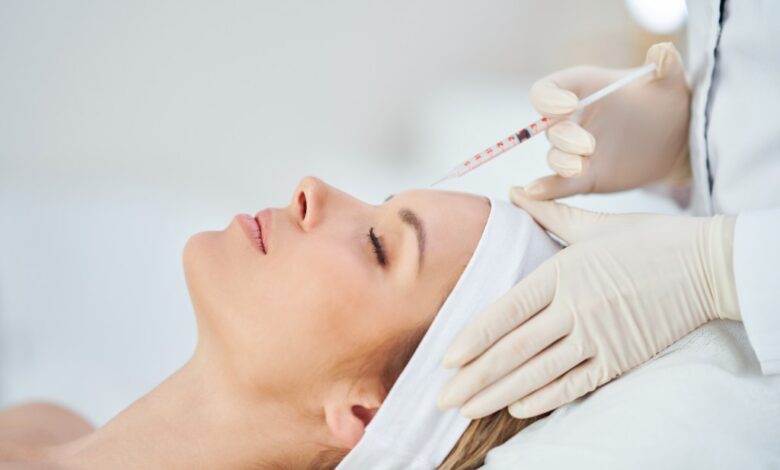 A woman receiving a botox injection as a part of medical cosmetology treatment