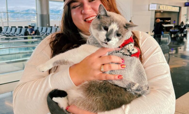 Janelle Rupkalvis and her four-year-old, part-Siamese pet cat, Asparagus, in an airport