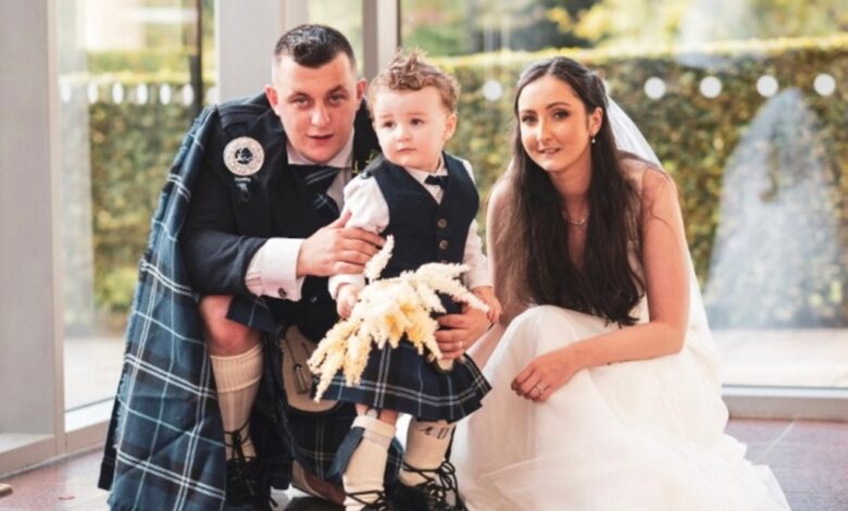 Newlyweds Danielle Thomson and Mark Brodie in wedding attire with their son Aaron at Crutherland House Hotel, South Lanarkshire, Scotland